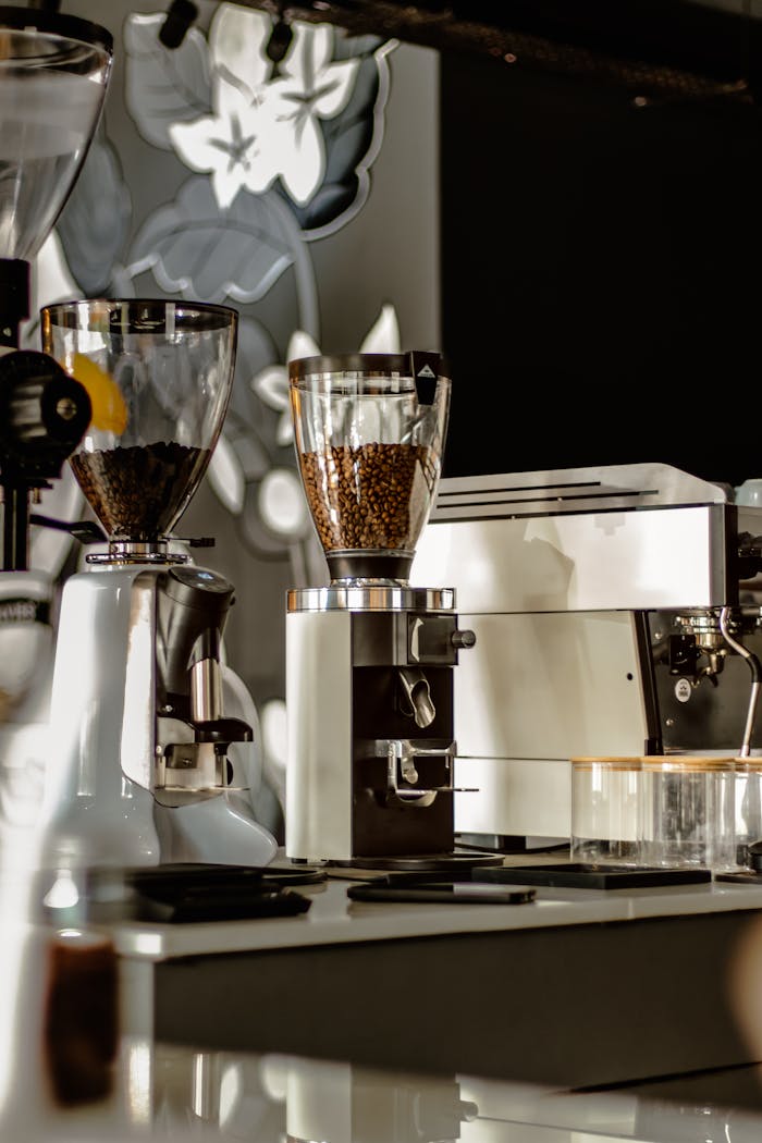 Coffee shop counter featuring grinders, coffee machines, and beans ready for brewing.